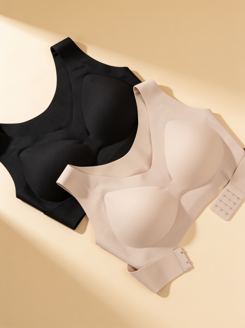 Posture bra in black and beige laid flat, moulded cups and side hook-and-eye closure